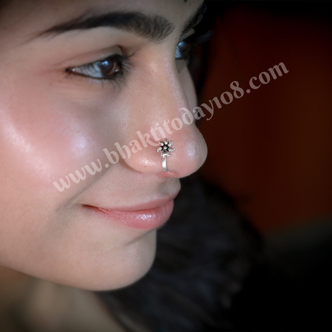 Silver nose stud featuring a delicate, handcrafted rose design. Elegant floral nose jewelry for a subtle and stylish piercing.