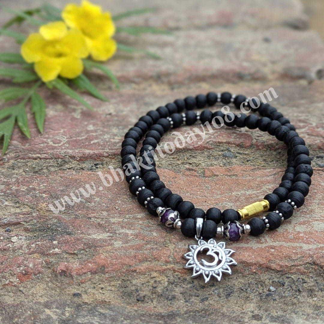 Tulsi silver bracelet with Om design – features sacred Tulsi beads interwoven with a silver Om symbol, representing spirituality and protection.
