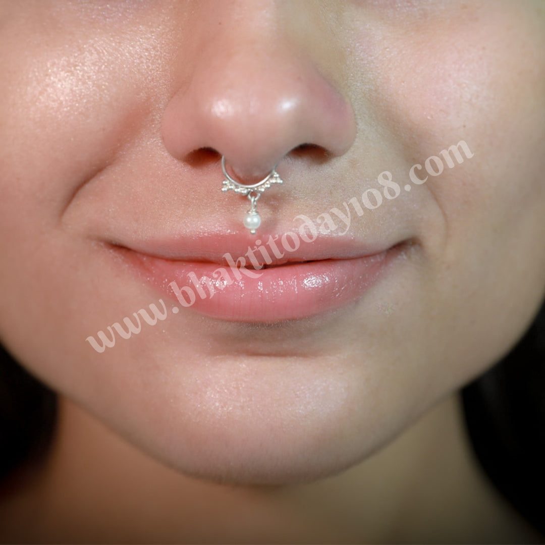 Sterling silver septum ring featuring a versatile design suitable for both septum and nostril piercings. Elegant and high-quality silver body jewelry.