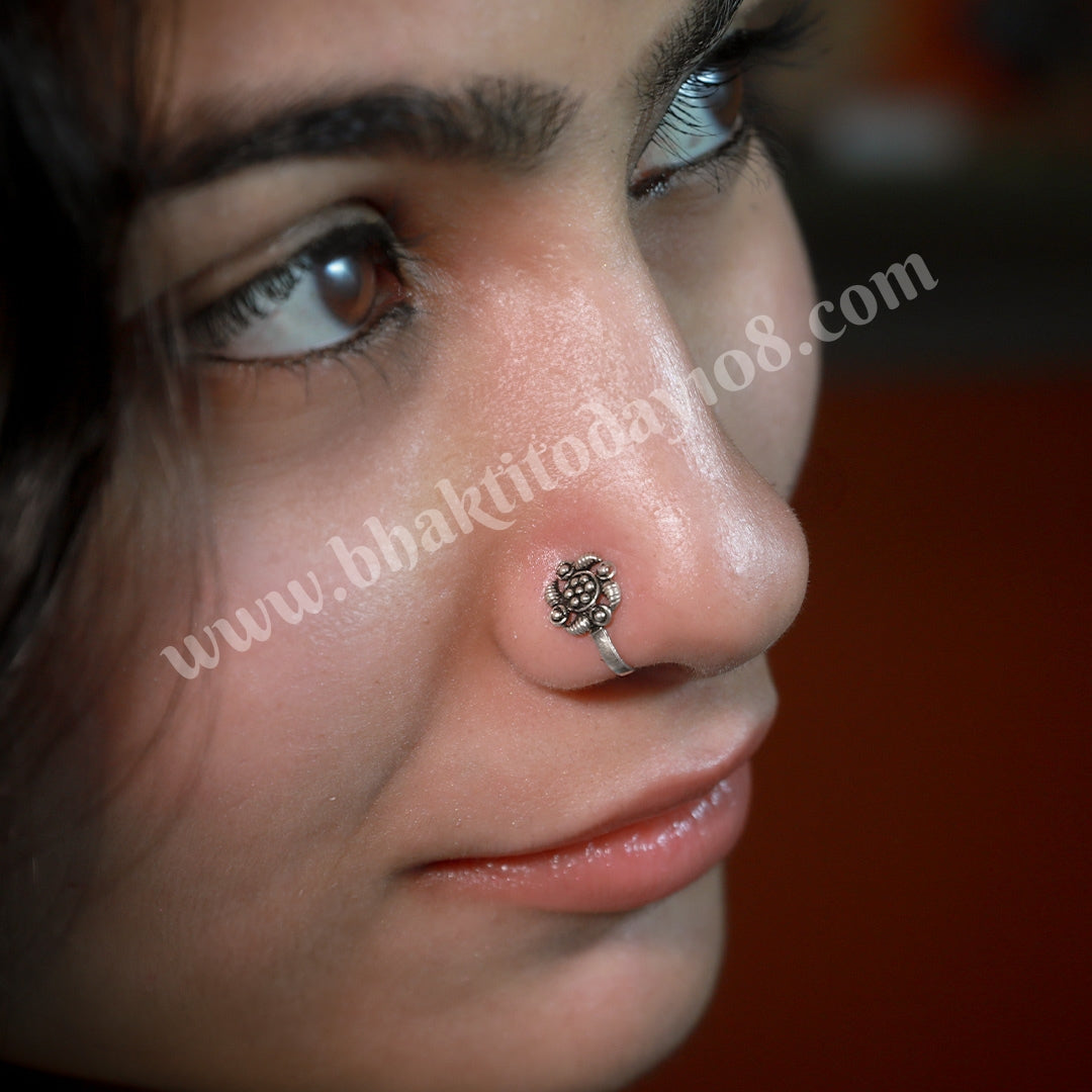 Silver nose stud featuring a delicate, handcrafted rose design. Elegant floral nose jewelry for a subtle and stylish piercing.