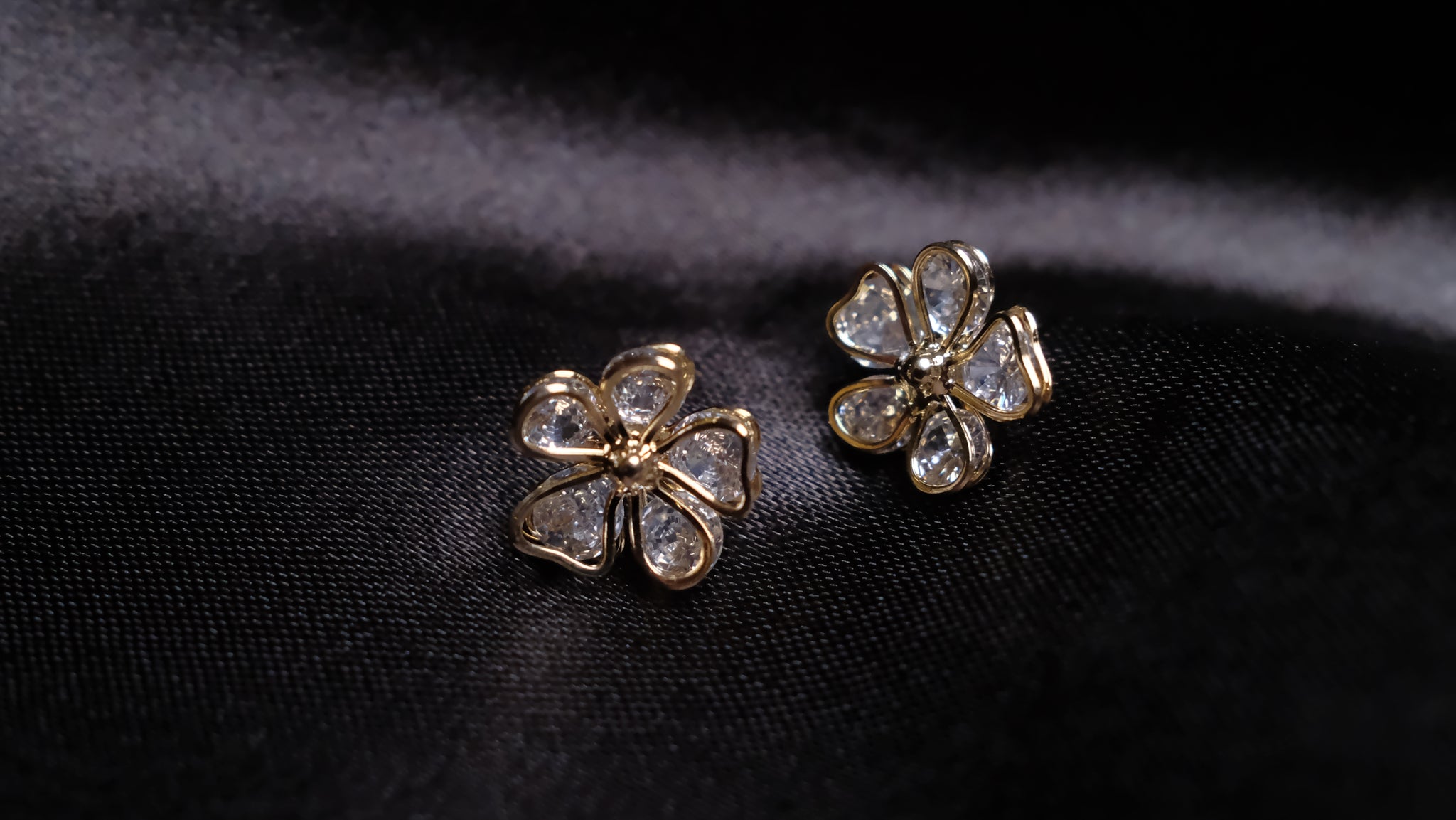 Gold-plated floral earrings featuring intricate petal designs with a radiant finish, combining elegance and nature-inspired charm.