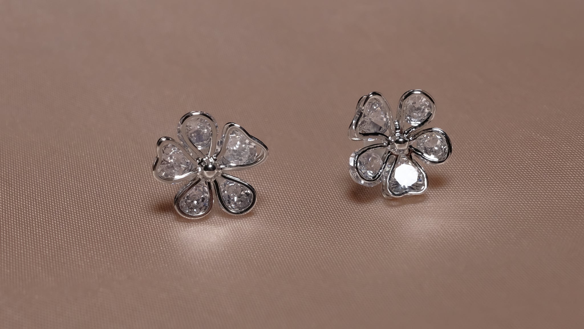 Silver-plated floral earrings with intricate petal designs, featuring a delicate and elegant finish.