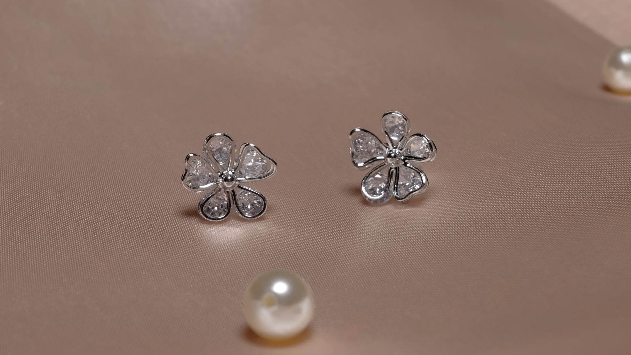 Silver-plated floral earrings with intricate petal designs, featuring a delicate and elegant finish.