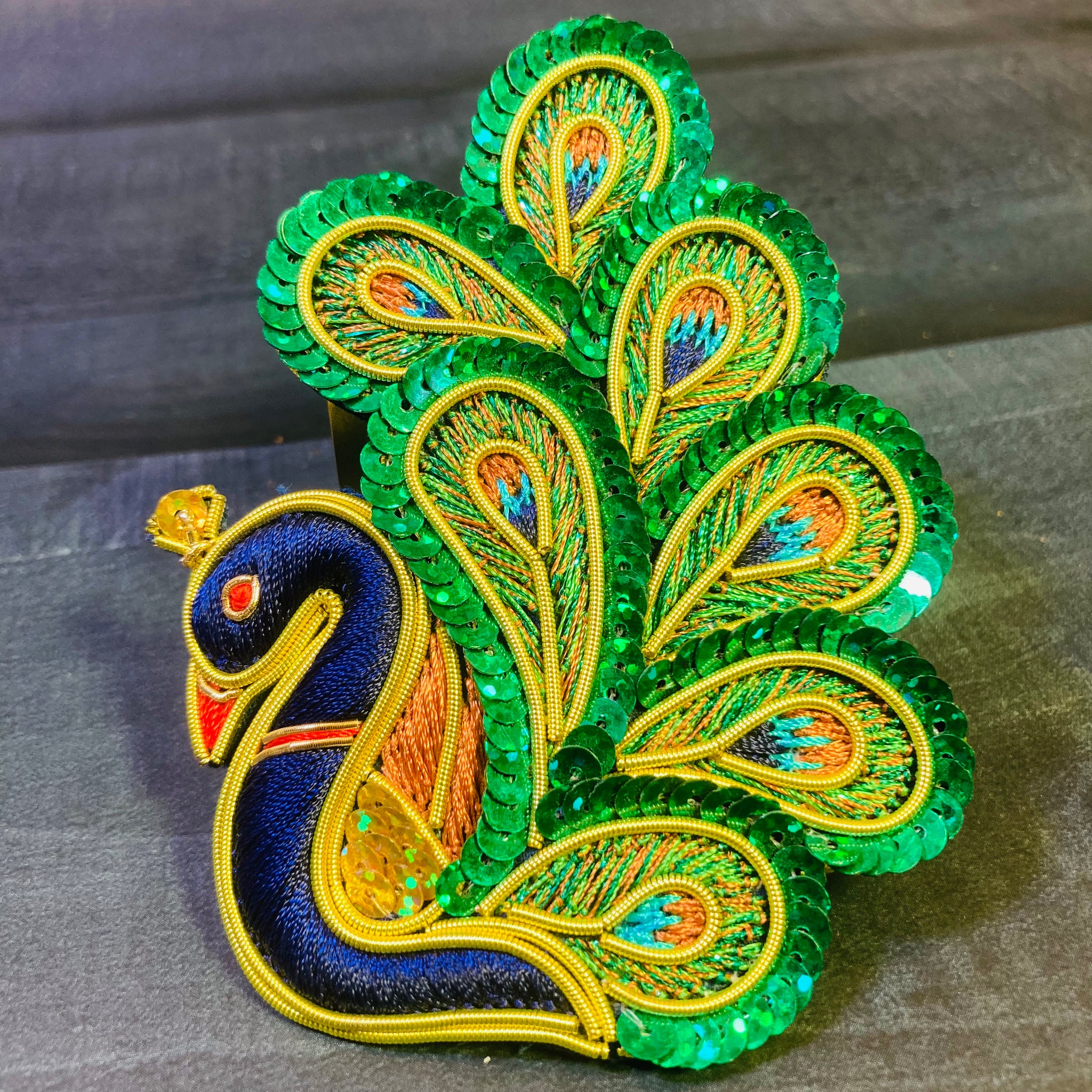 A beautifully crafted Royal Peacock embroidered piece featuring intricate threadwork, vibrant colors, and detailed patterns showcasing the majestic peacock design—perfect for home décor or traditional art display.