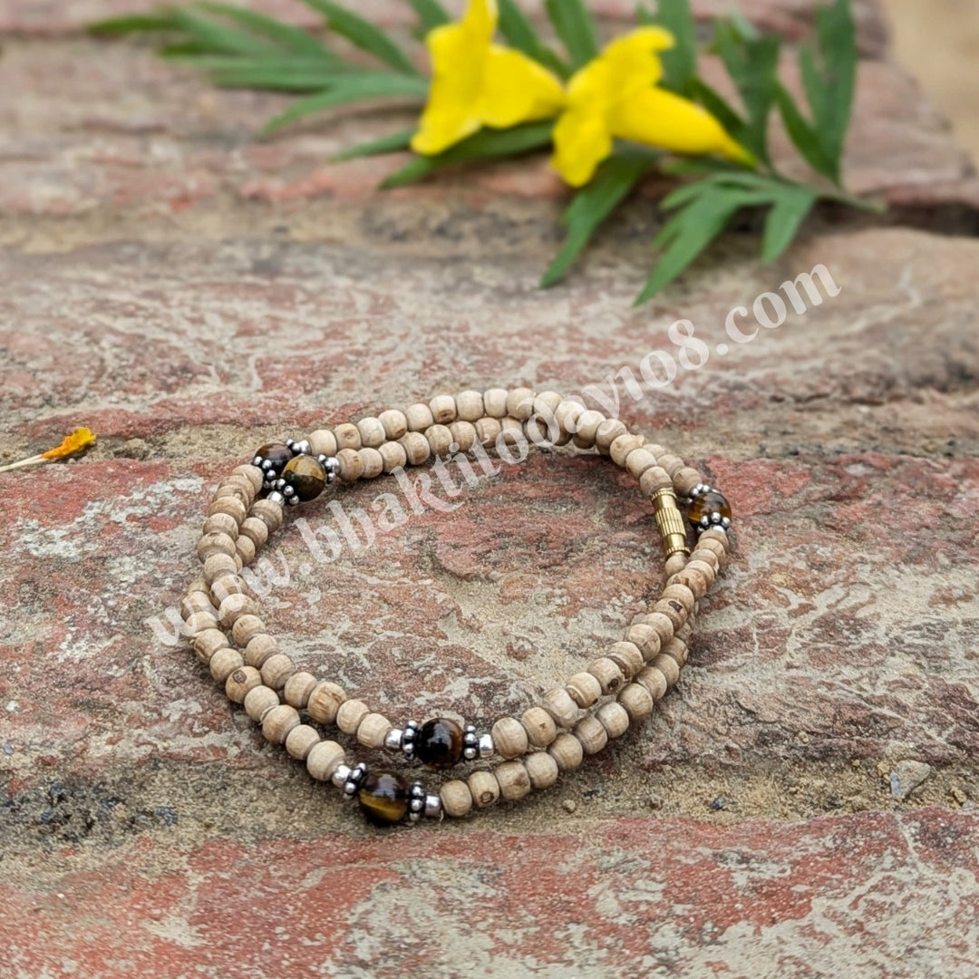 Tulsi Kanthi Mala with Tiger Eye and silver stones – a handcrafted spiritual necklace combining sacred Tulsi beads, protective Tiger Eye stones, and elegant silver accents.