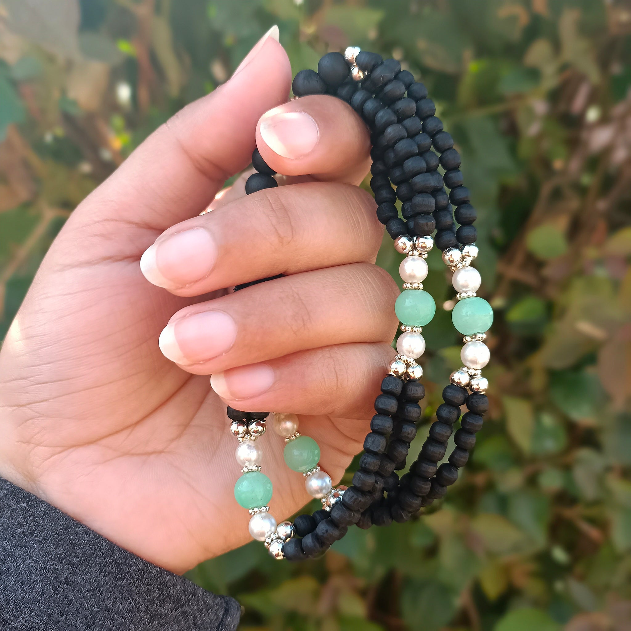 Three-layer pure Vrindavan Tulsi beads with silver accents and shining stones, offering divine protection and spiritual elegance.