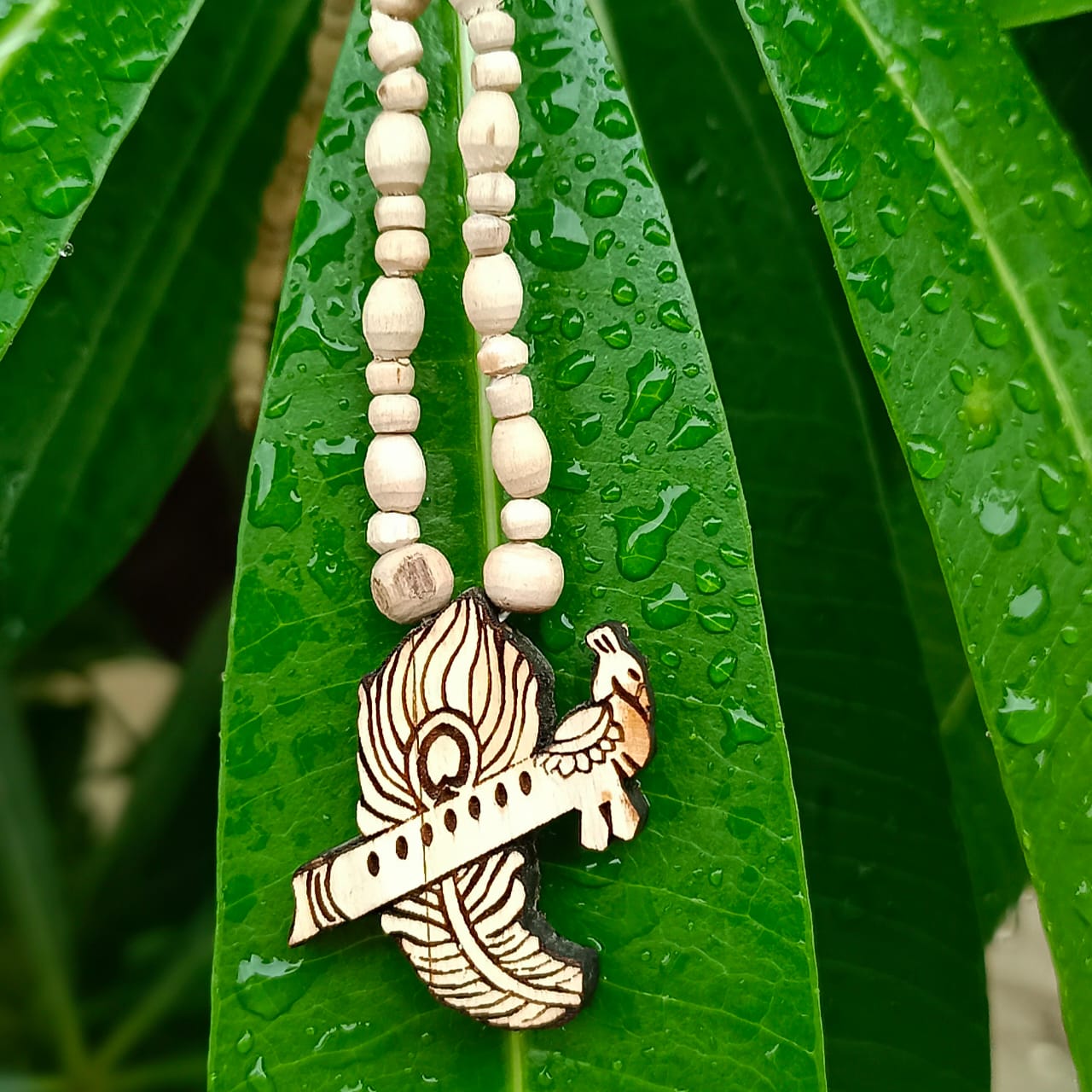 Flute & Peacock Feather Tulsi Kanthi Mala – Pure Vrindavan Tulsi beads with flute and peacock feather pendant, symbolizing Krishna’s divine presence and protection.